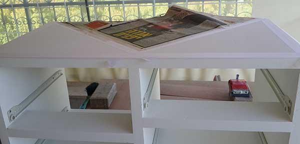 front look, top covered with type and paper, exposing 2 triangles, one on each end